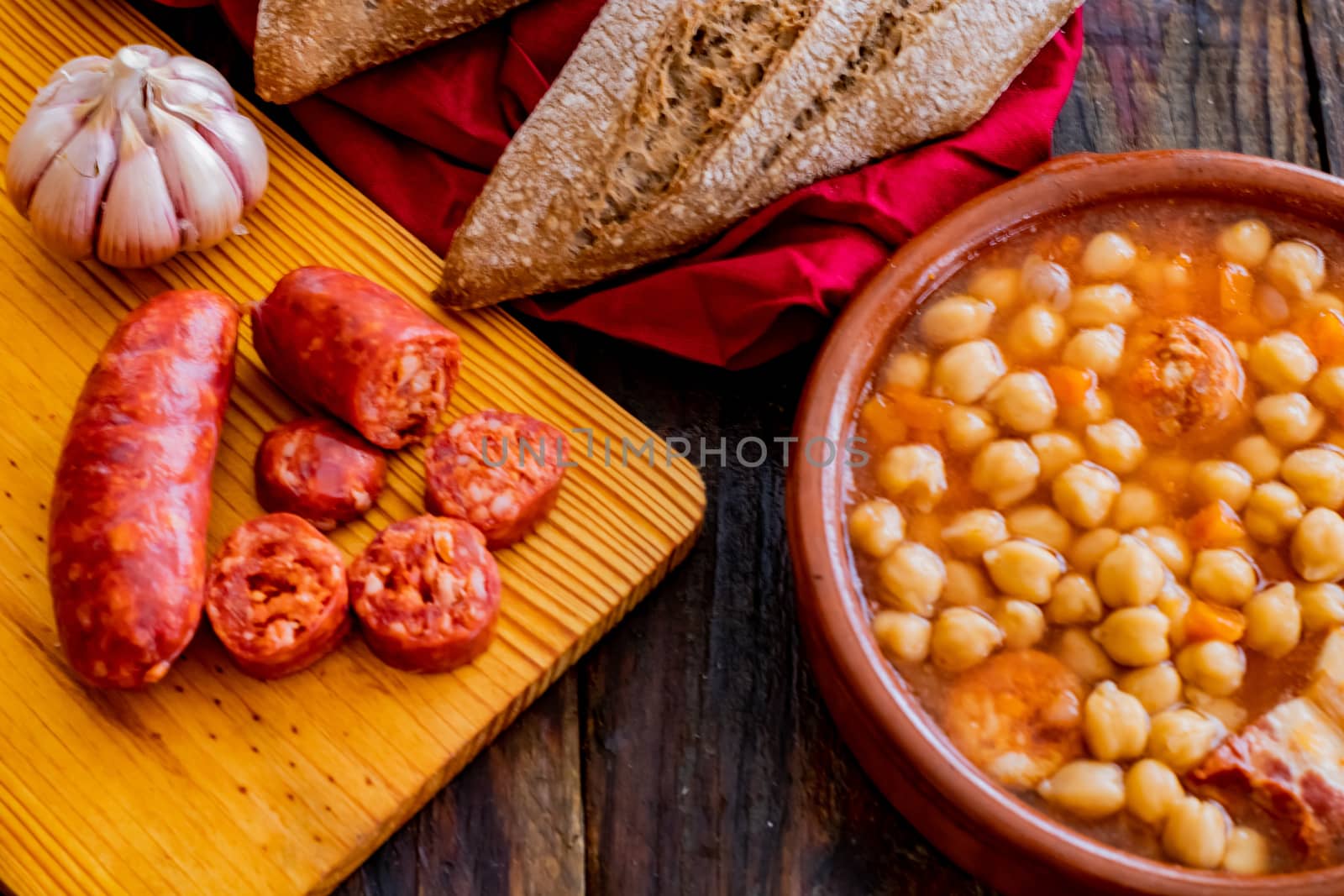Chickpea dish and ingredients in composition on wooden background