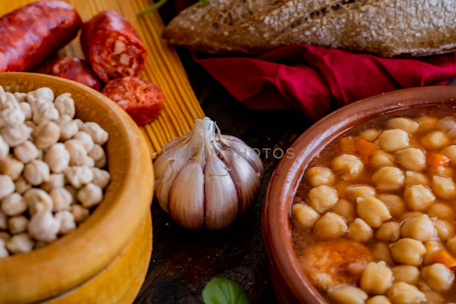 Chickpea dish and ingredients in composition on wooden background