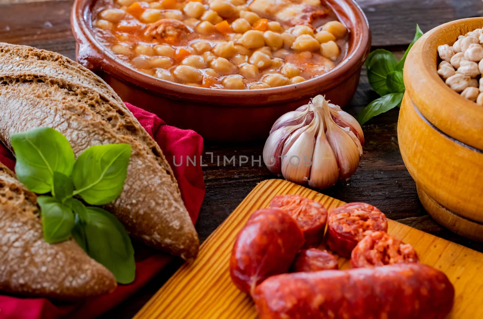 Chickpea dish and ingredients in composition on wooden background