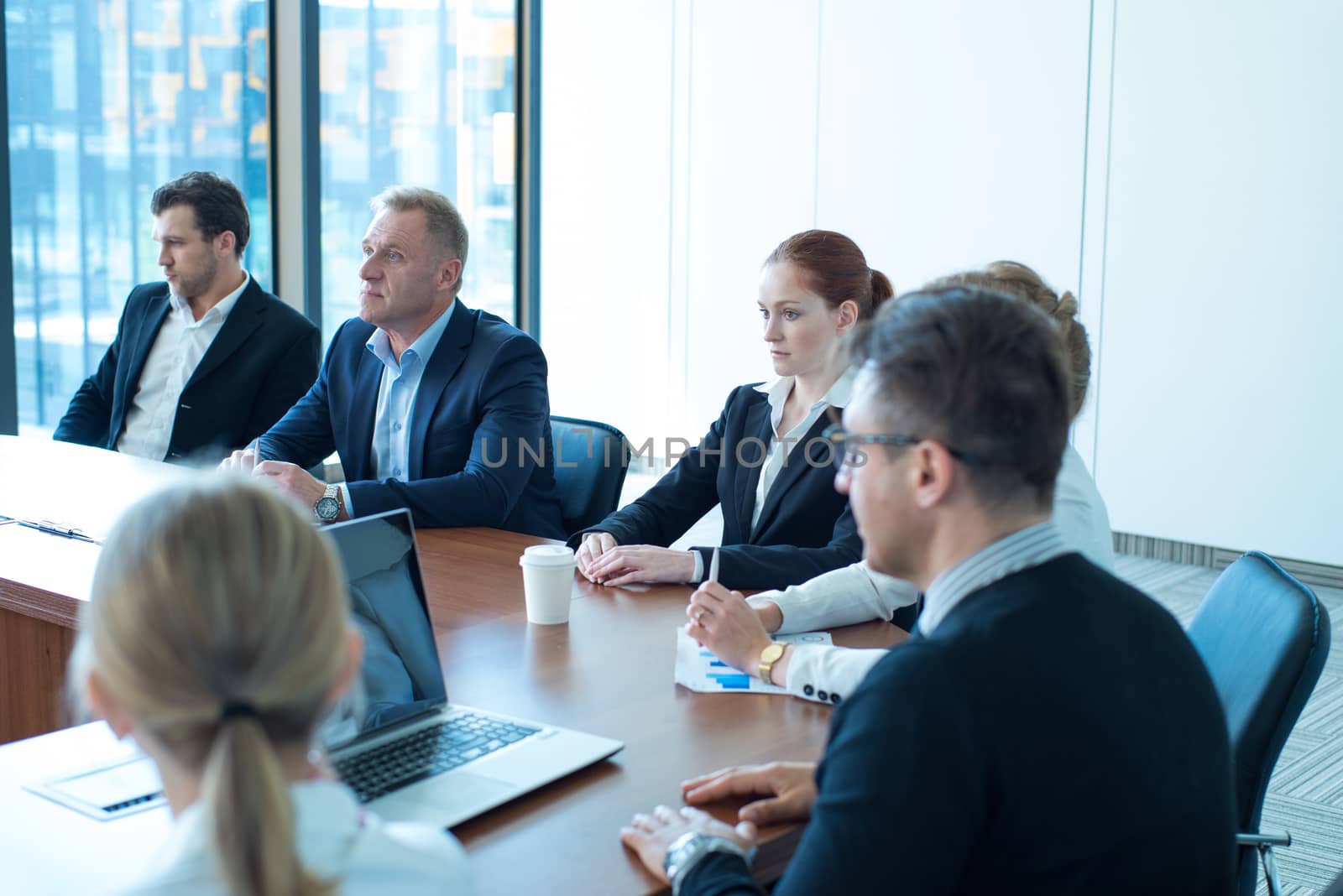 Image of business partners discussing documents and ideas at meeting