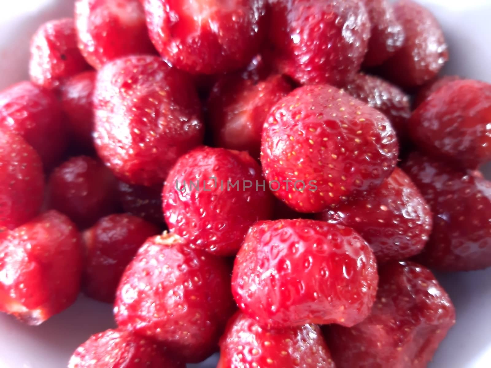 Colored fruit background. Strawberries close up. Photo of useful berries. Vegetarian food. Delicious and healthy dessert, vitamins.