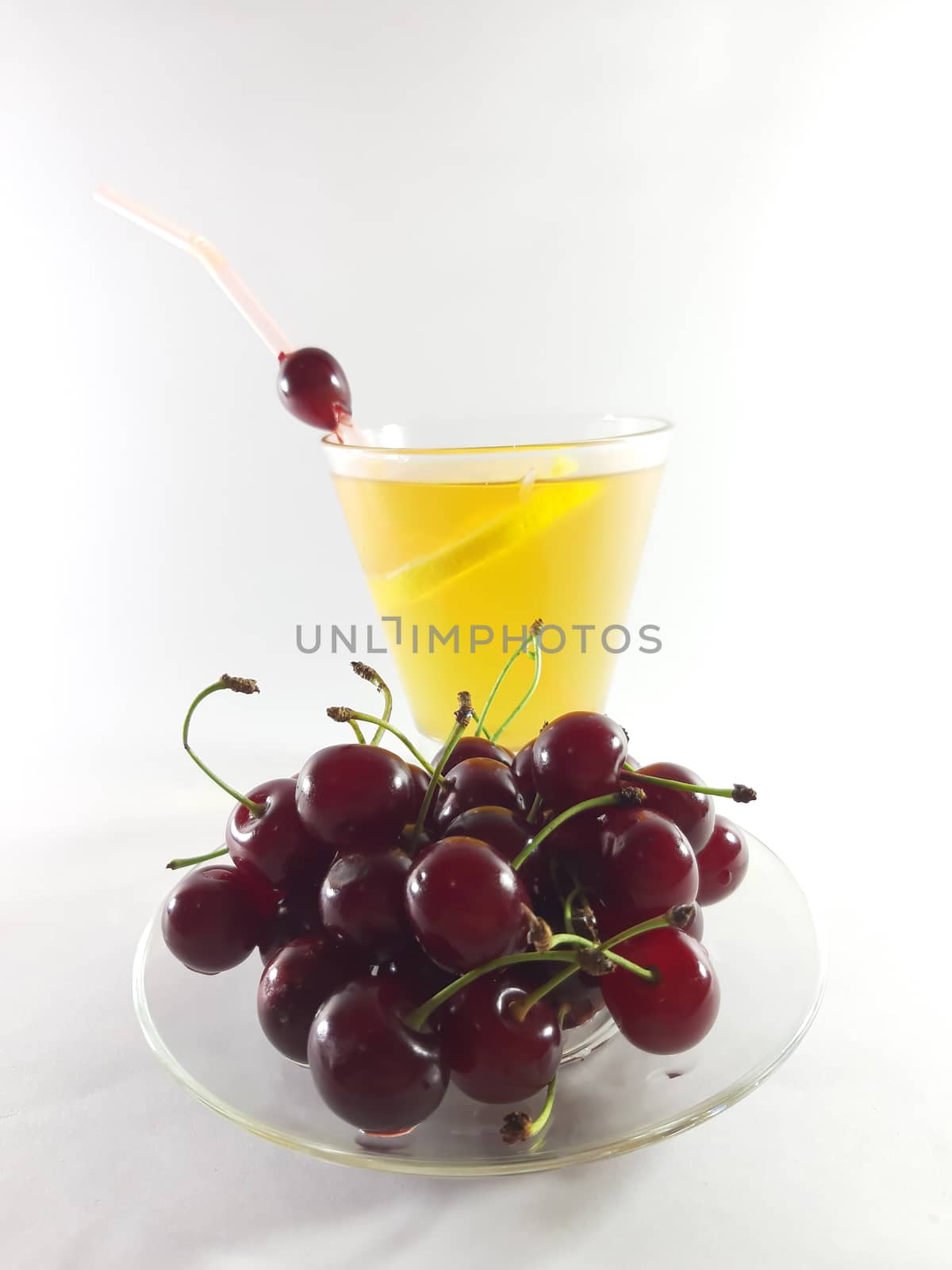 Drink with fruit in a transparent glass. Lemon and cherry for a  by polyachenkovv@gmail.com