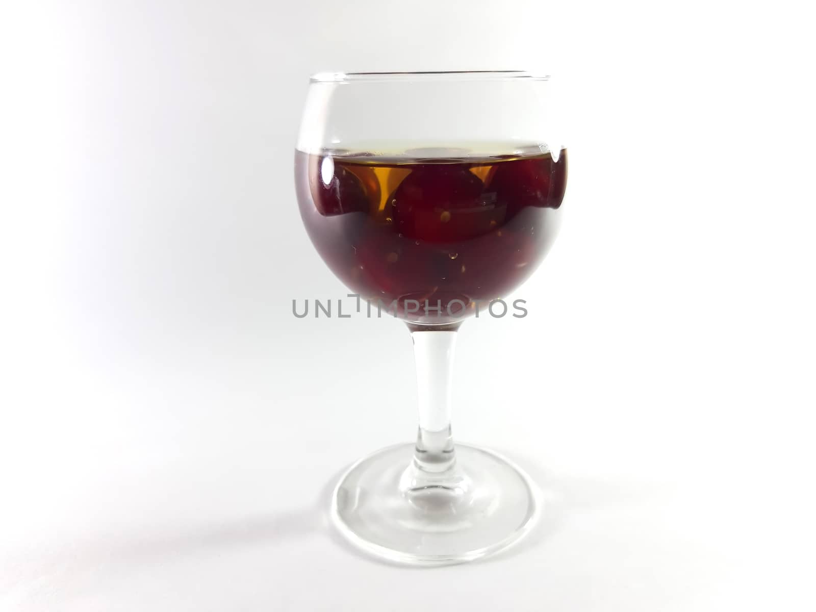 Drink with fruit in a transparent glass. Cherry for a snack. Liq by polyachenkovv@gmail.com