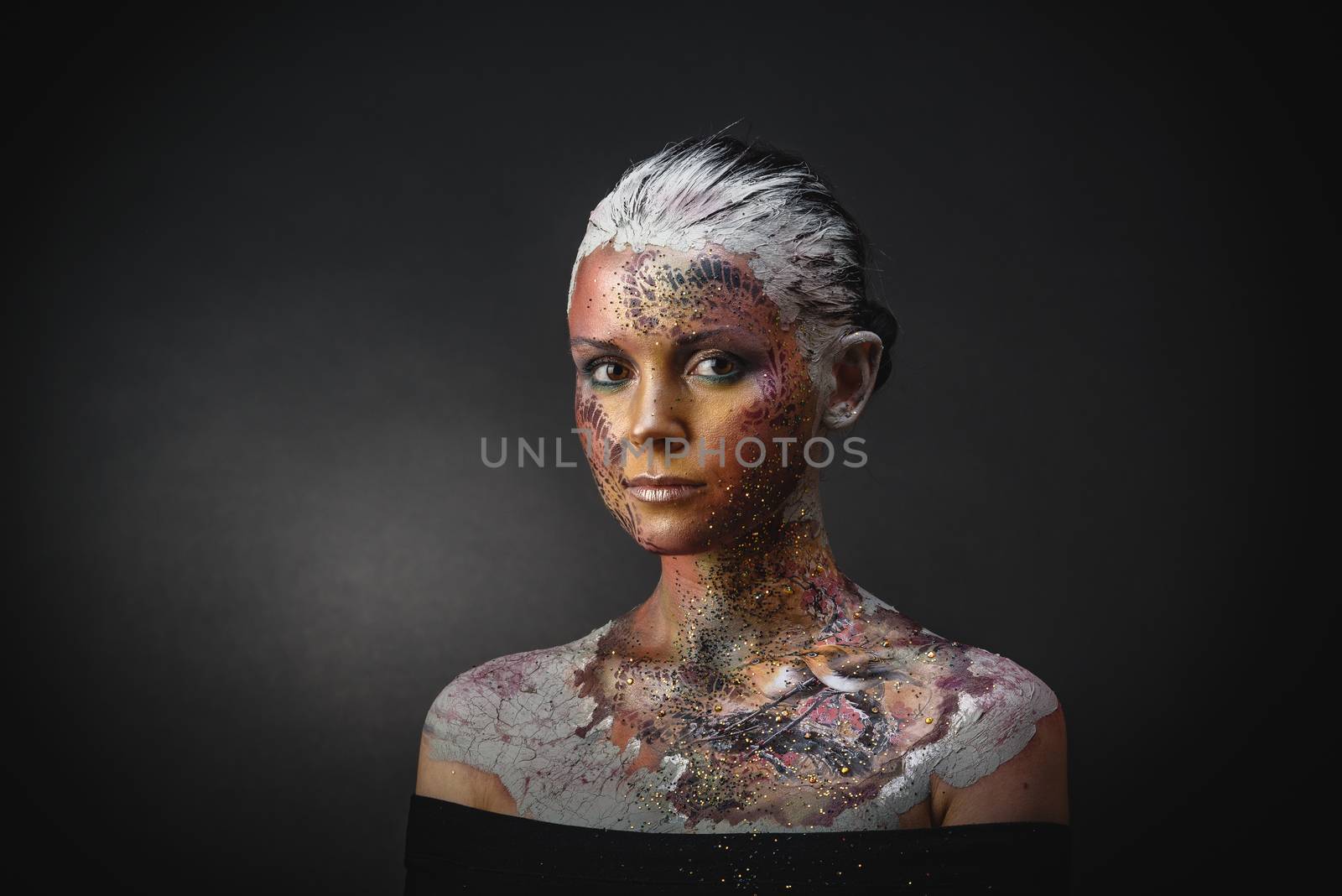 Portrait of Beautiful Young Woman with creative fantasy bird makeup