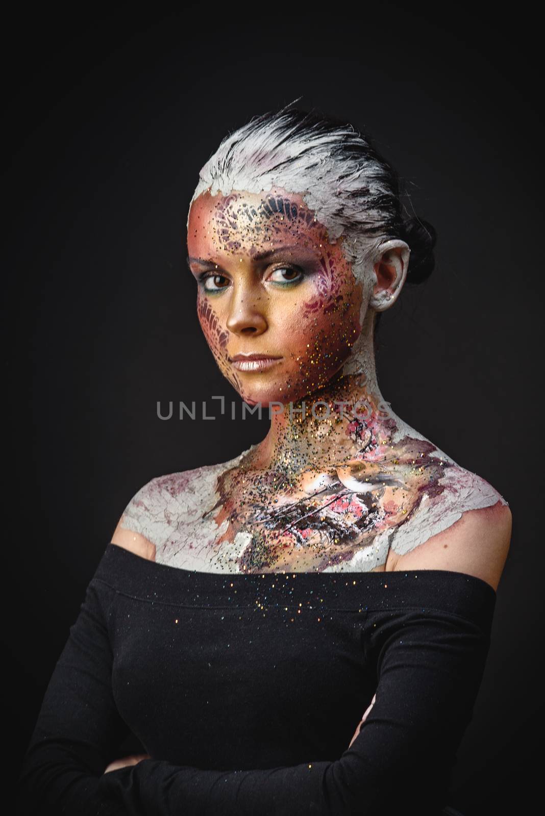 Portrait of Beautiful Young Woman with creative fantasy bird makeup