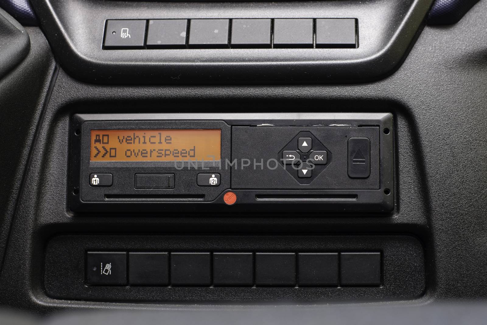 Digital tachograph display reads Vehicle Overspeed. No personal data. Tachograph in a van by vladiczech