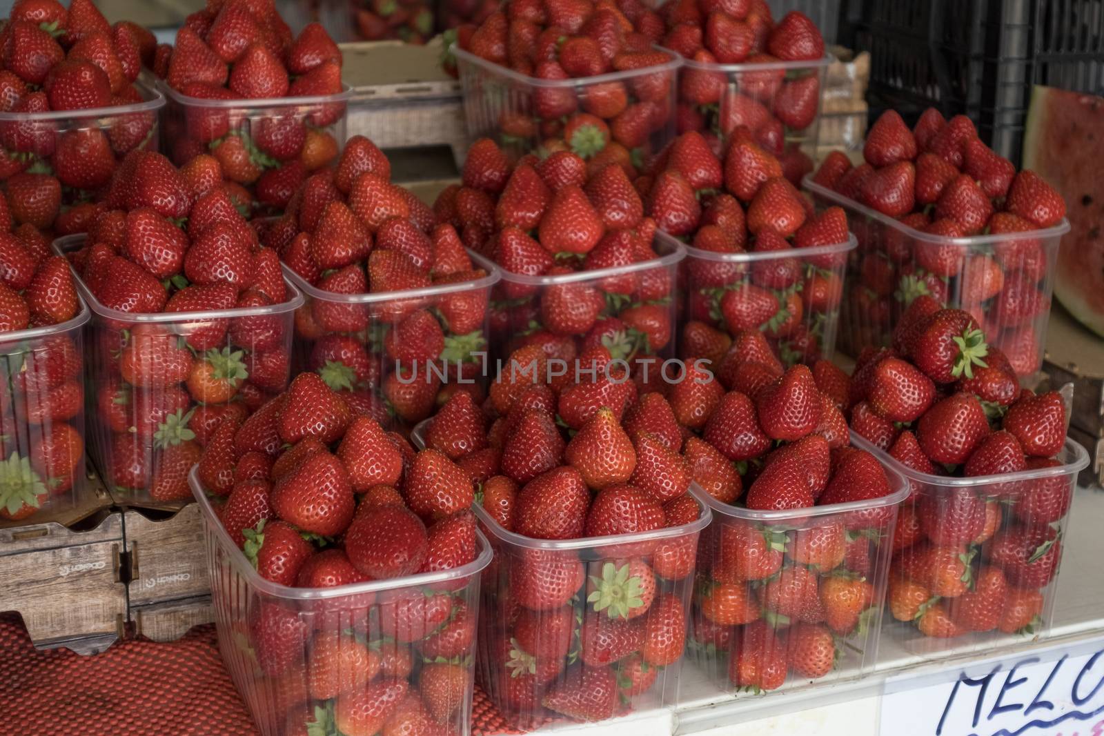 basket of red ripe strawberries for sale in the steet shop.