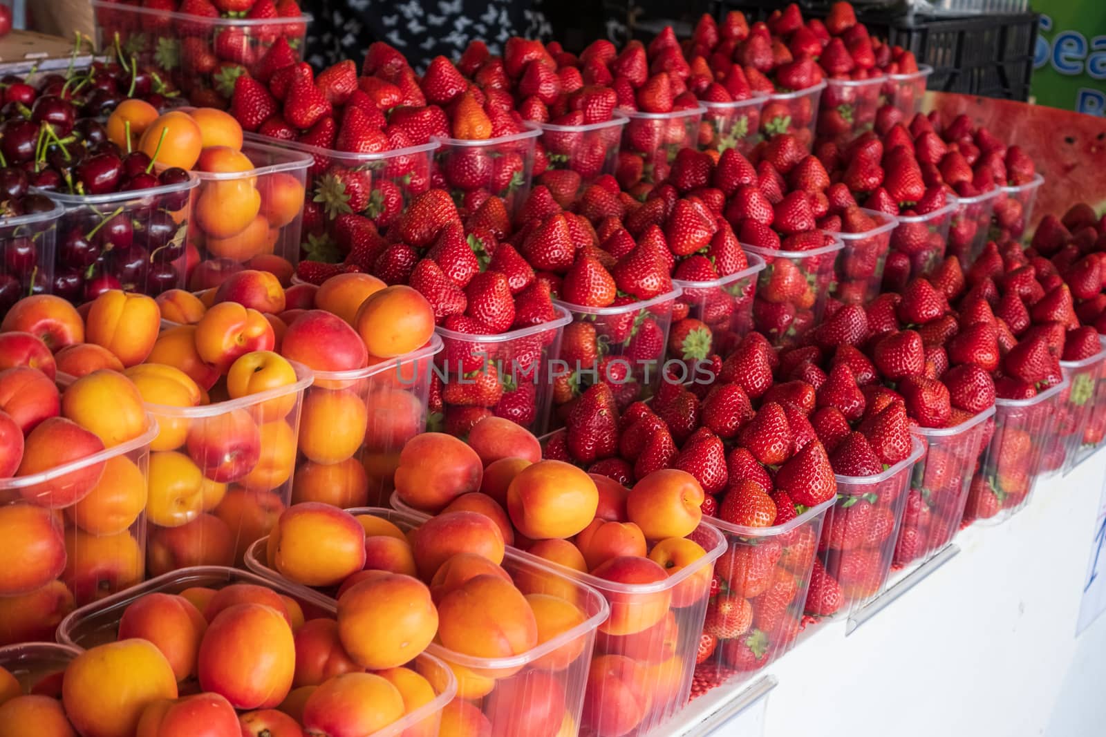 basket of red ripe strawberries and apricots by Robertobinetti70