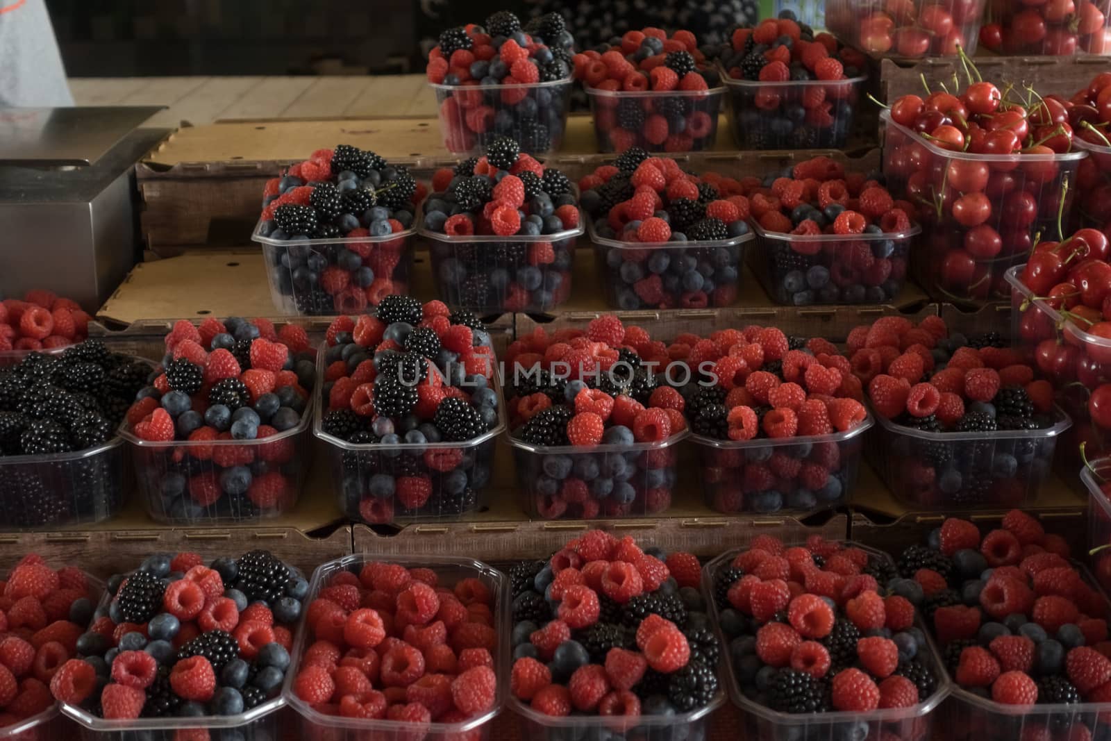 Fresh berries on box  sale at the market.blueberries,  raspberry and blackberries on a market stall.