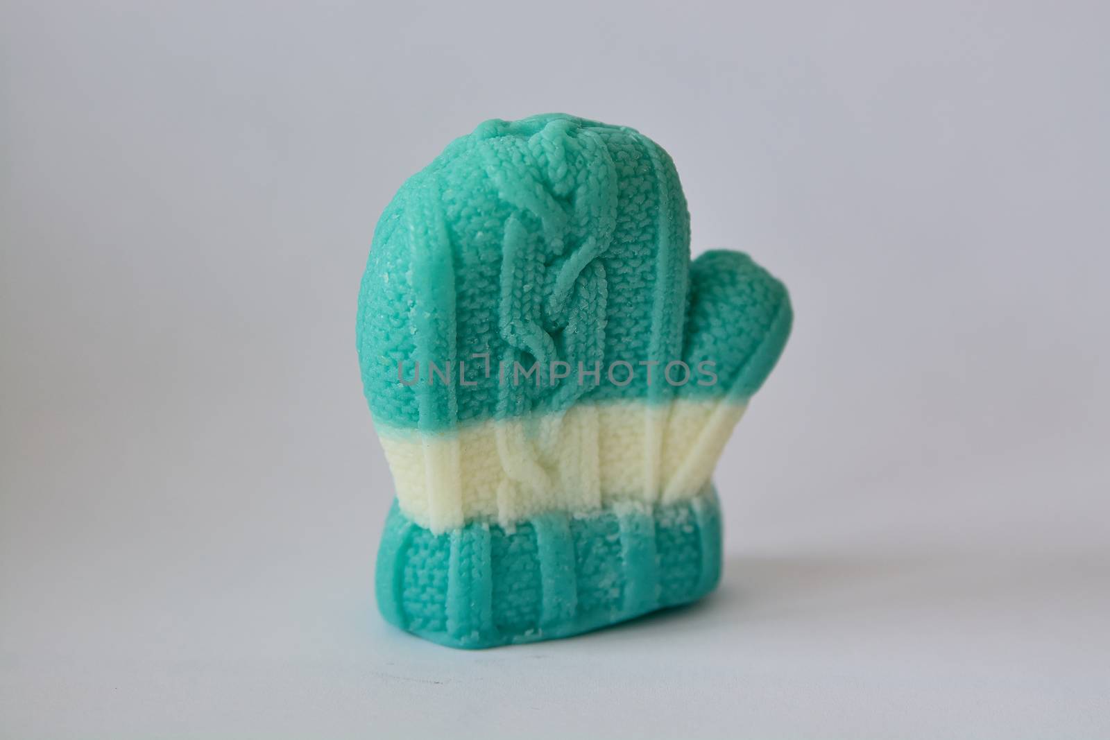 Soap gift in the form of winter mittens on a gray background.
