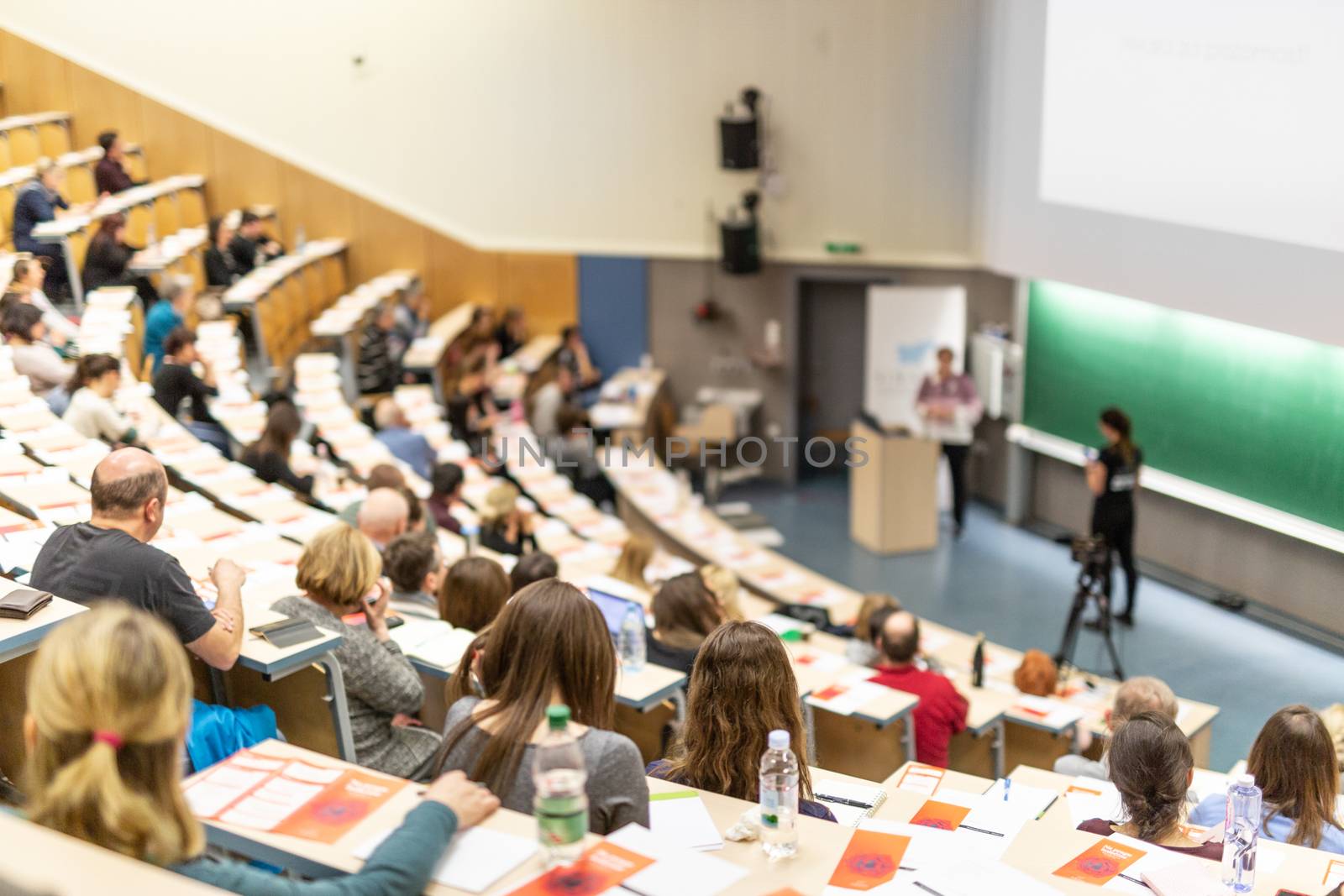 Conference and Presentation. Audience at the conference hall. Business and Entrepreneurship. Faculty lecture and workshop. Audience in the lecture hall. Academic education. Participants making notes.