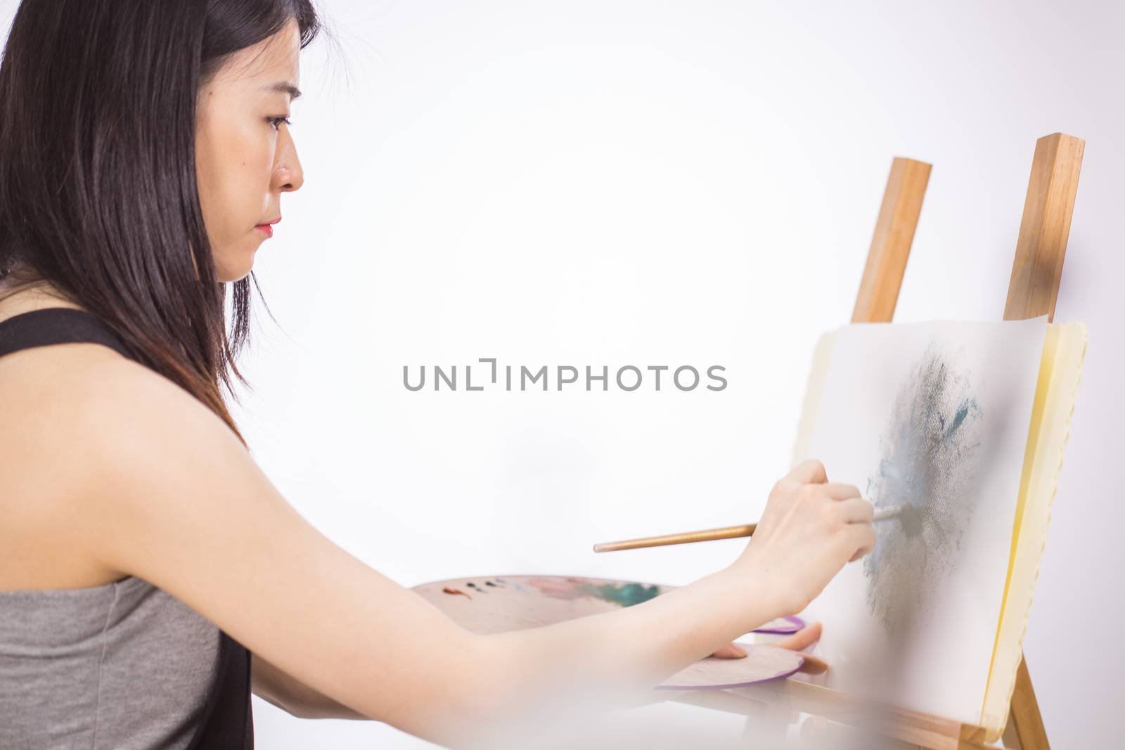 Artist painting oil painting on an easel