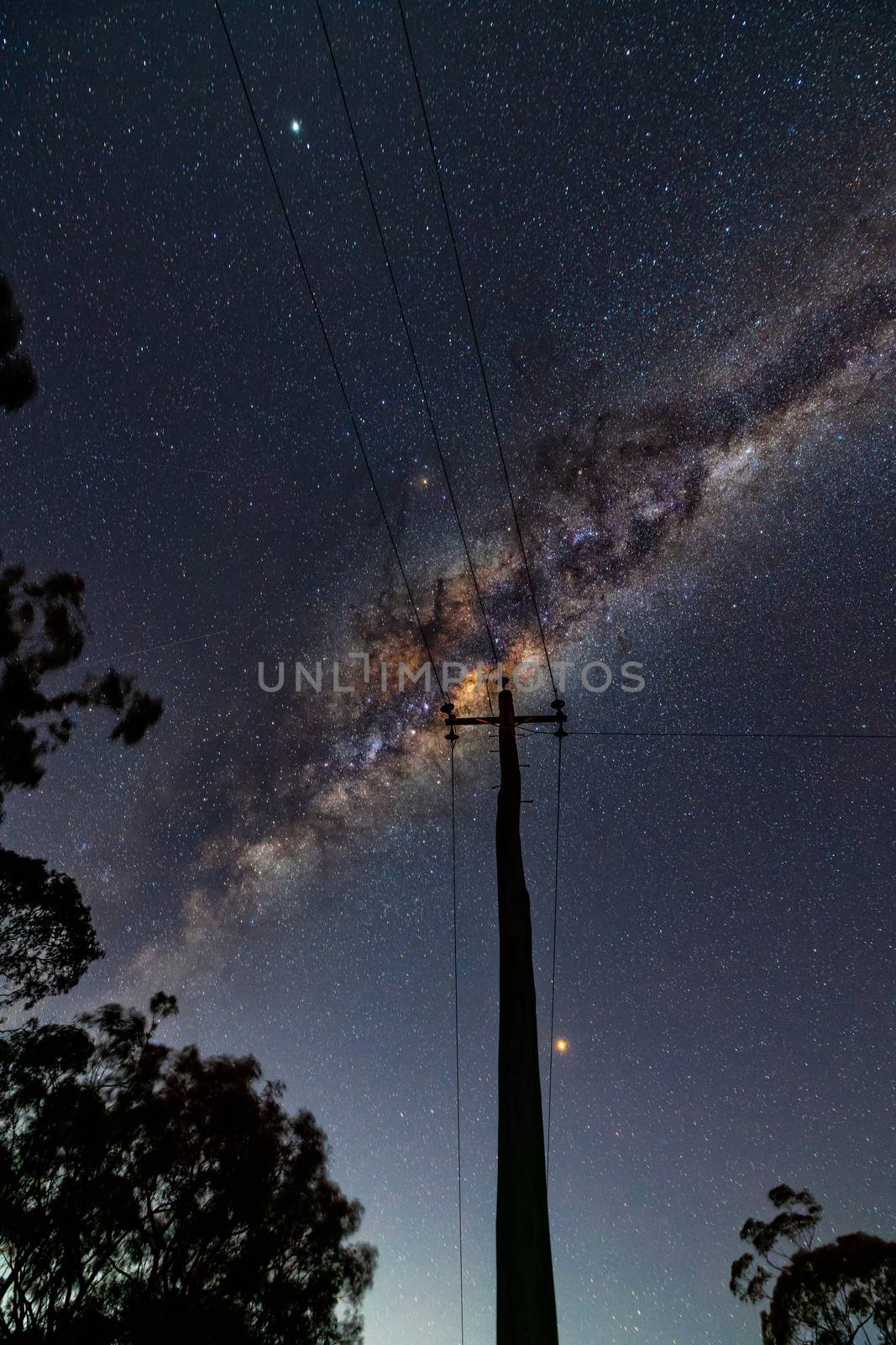 Milky way universe, shining stars and galactic core high in the sky over suburbia