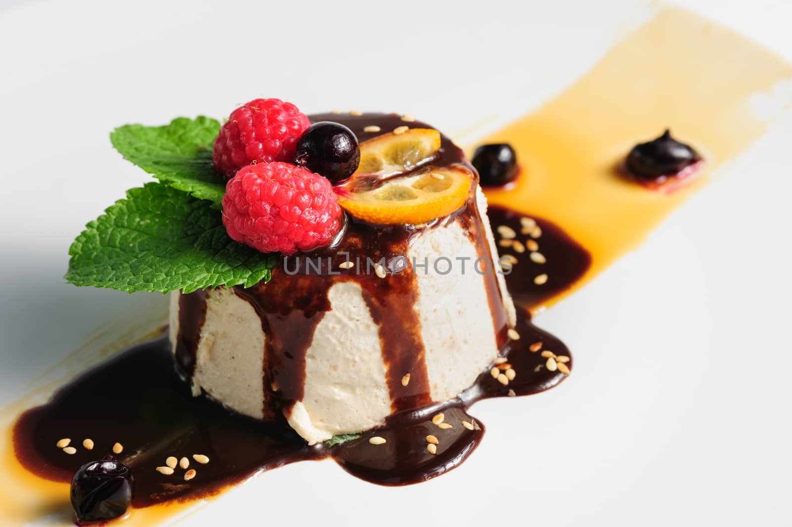 semifredo, italian ice cream dessert with halva, raspberry and chocolate sauce on top