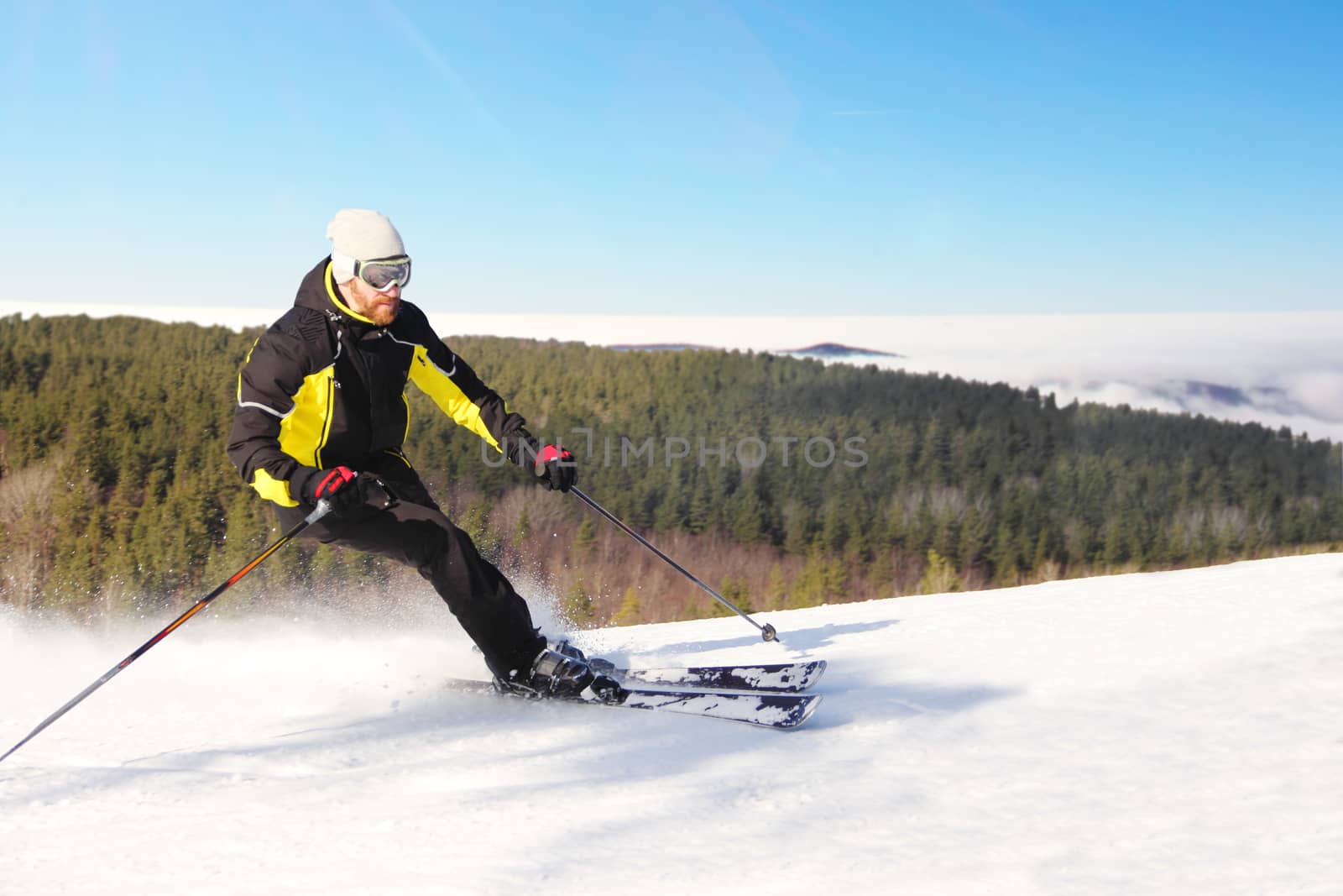 Skier skiing downhill in morning mountains, resort Spindleruv Mlyn, Krkonose, Czech Republic