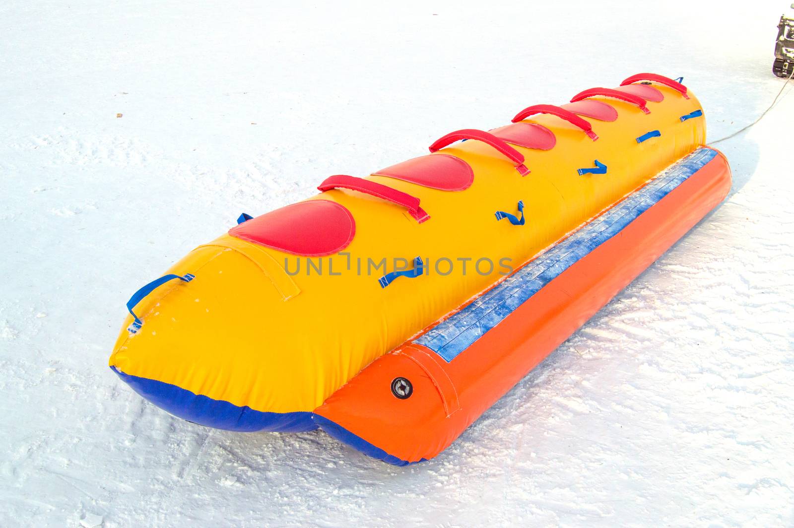 Inflatable rubber multi-seat sleigh for high-speed snow skiing in winter, winter activity concept and Christmas fun.