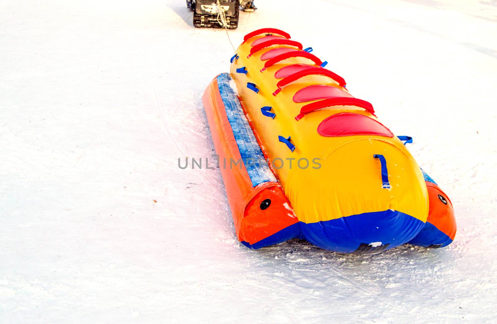 Inflatable rubber multi-seat sleigh for high-speed snow skiing in winter, winter activity concept and Christmas fun.