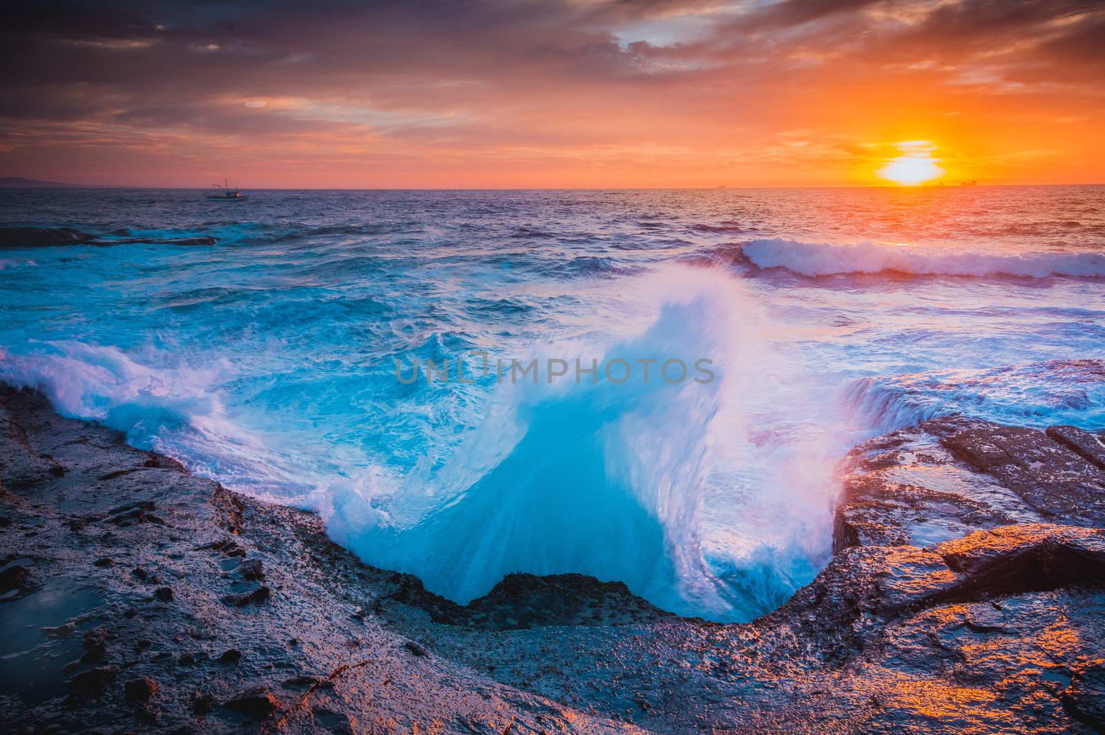 The whooosh of waves as they break over the coastal rocks by lovleah