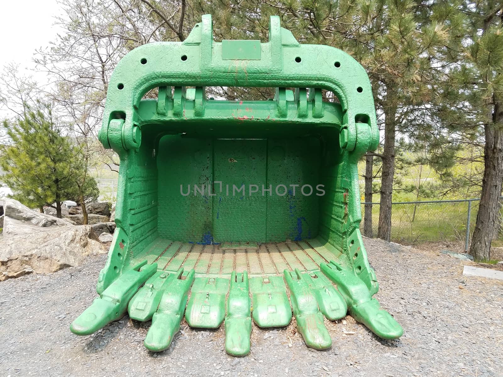 large green metal excavating or mining claw or scoop machine part