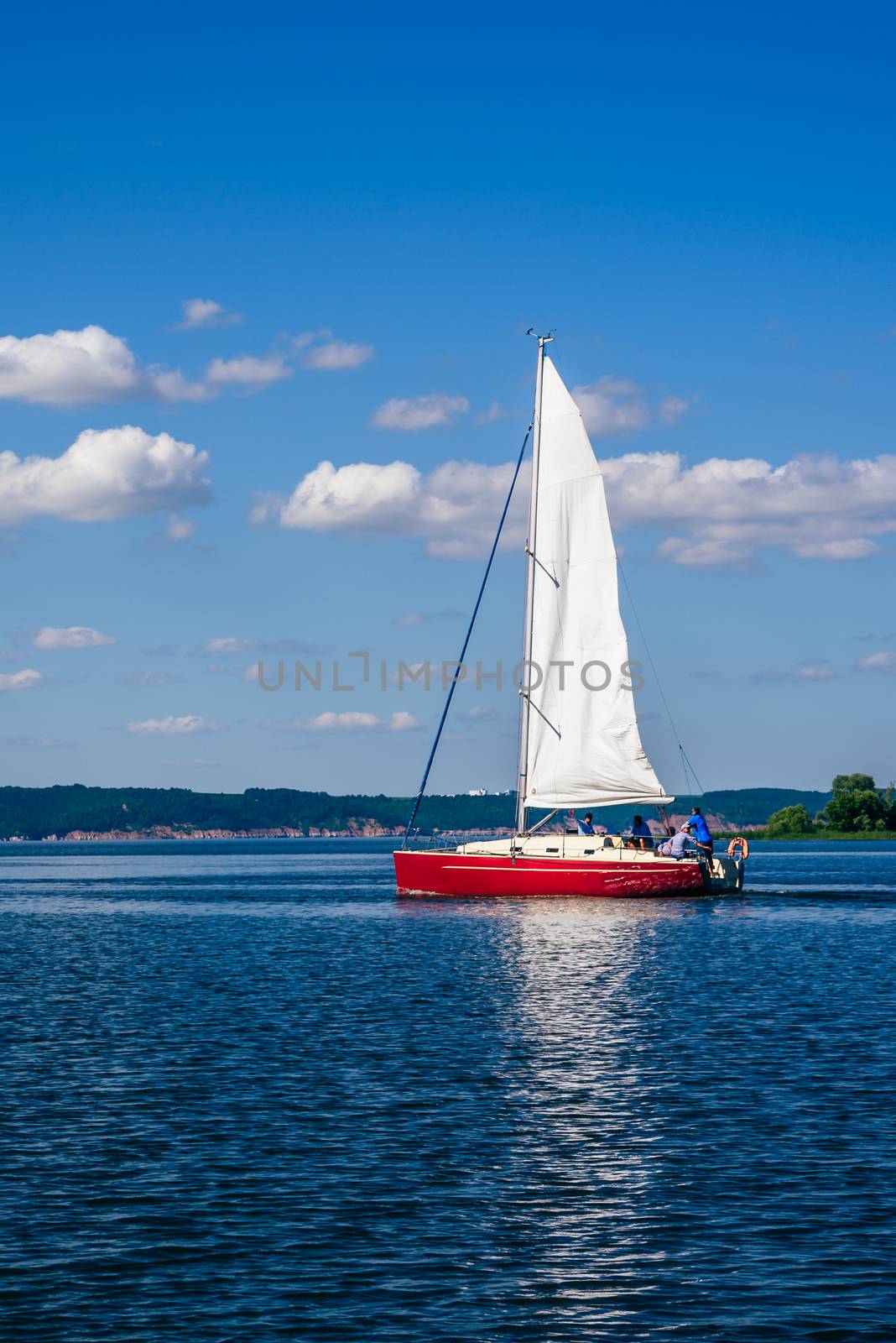 Red Sailing Boat on the River at Sunny Day.