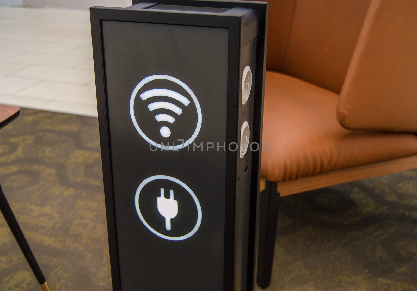 Stand tower for charging mobile phones in a shopping center, the sign of a wifi zone, background rest areas and service, the concept of the care experience and service.