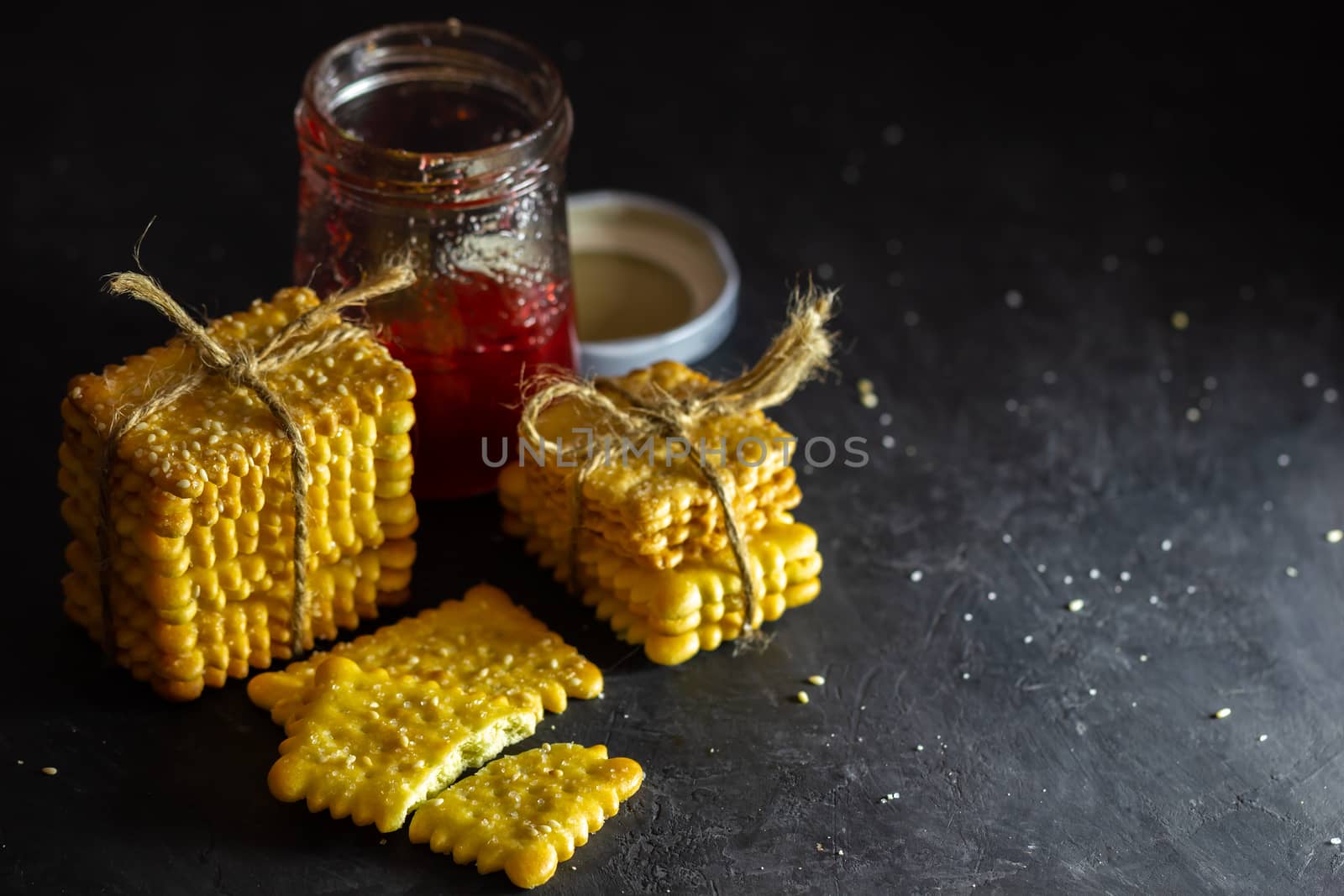 Crackers are tied with hemp rope and strawberry jam bottle on ta by SaitanSainam