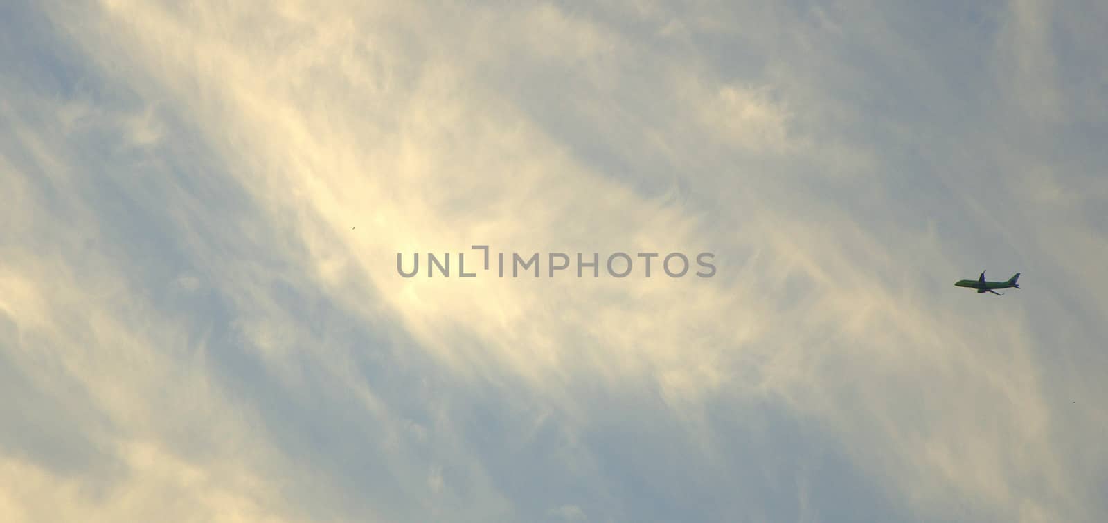 The silhouette of the aircraft in the sky against the background of cirrus clouds. Cloudscape. by alexey_zheltukhin