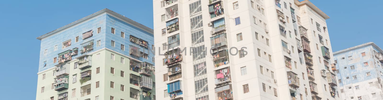 Panorama view typical high-rise apartment complex in Hanoi, Vietnam with hanging clothes over balcony