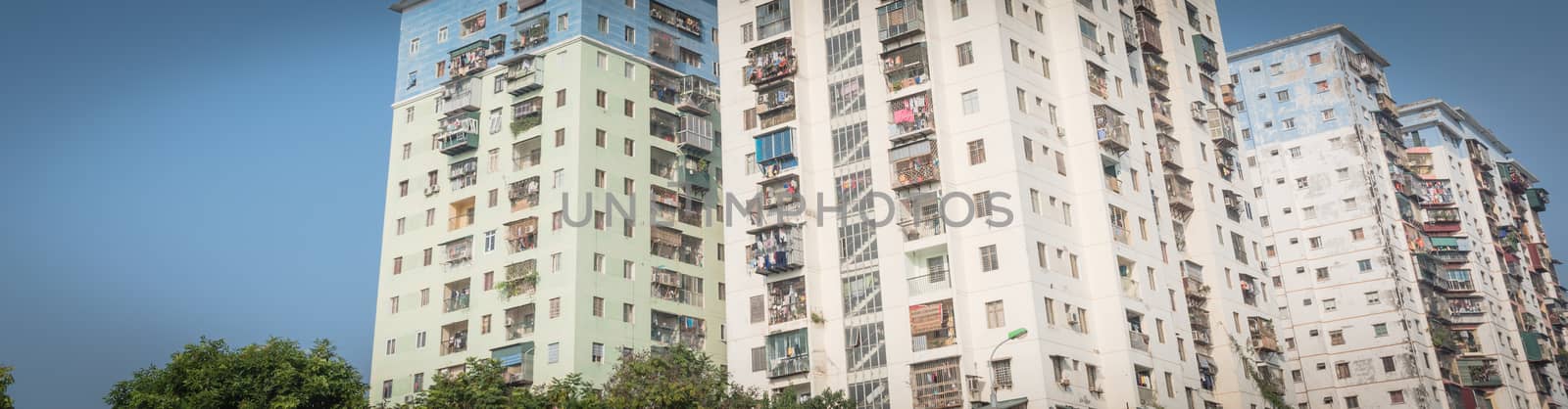 Panorama view typical high-rise apartment complex in Hanoi, Vietnam with hanging clothes over balcony