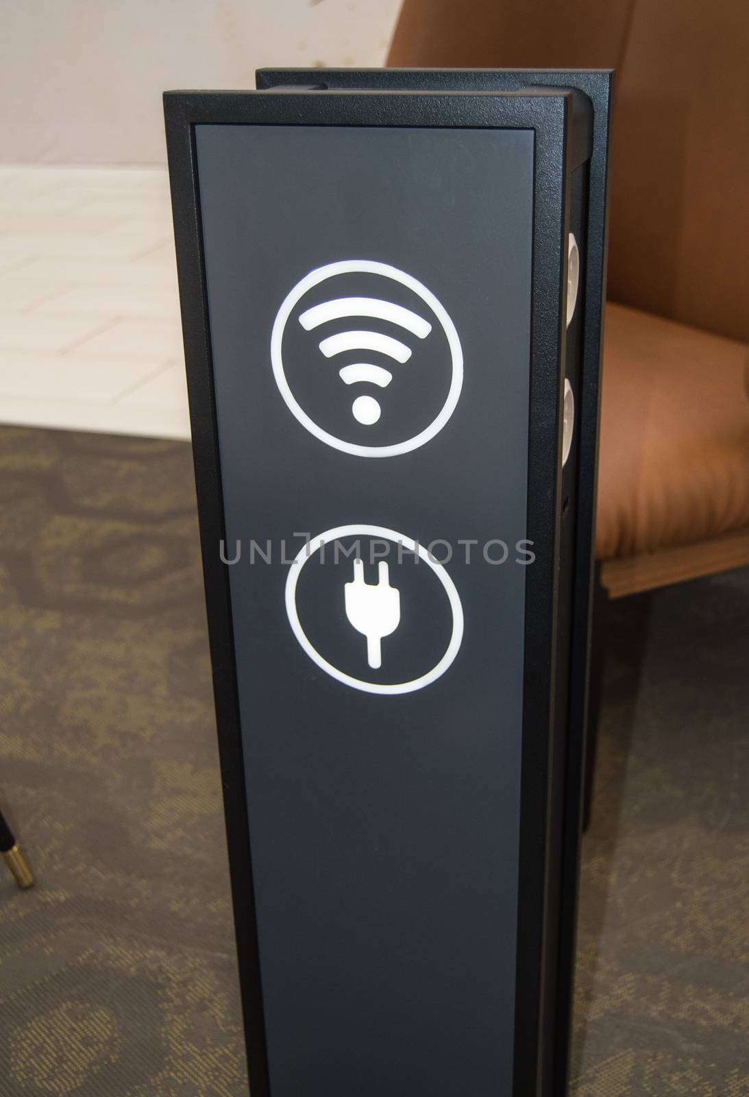 Stand tower for charging mobile phones in a shopping center, the sign of a wifi zone, a vertical image, background rest areas and service, the concept of the care experience and service.