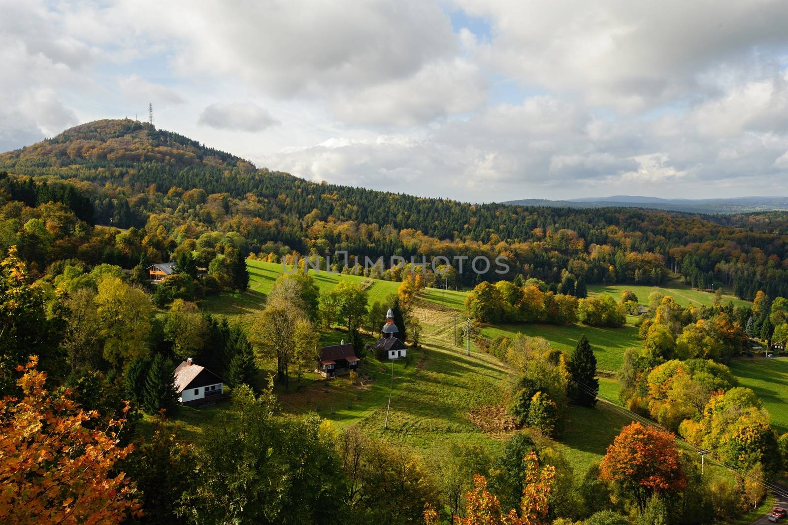 Autumn colorful landscape with forests, hills, sun and sky