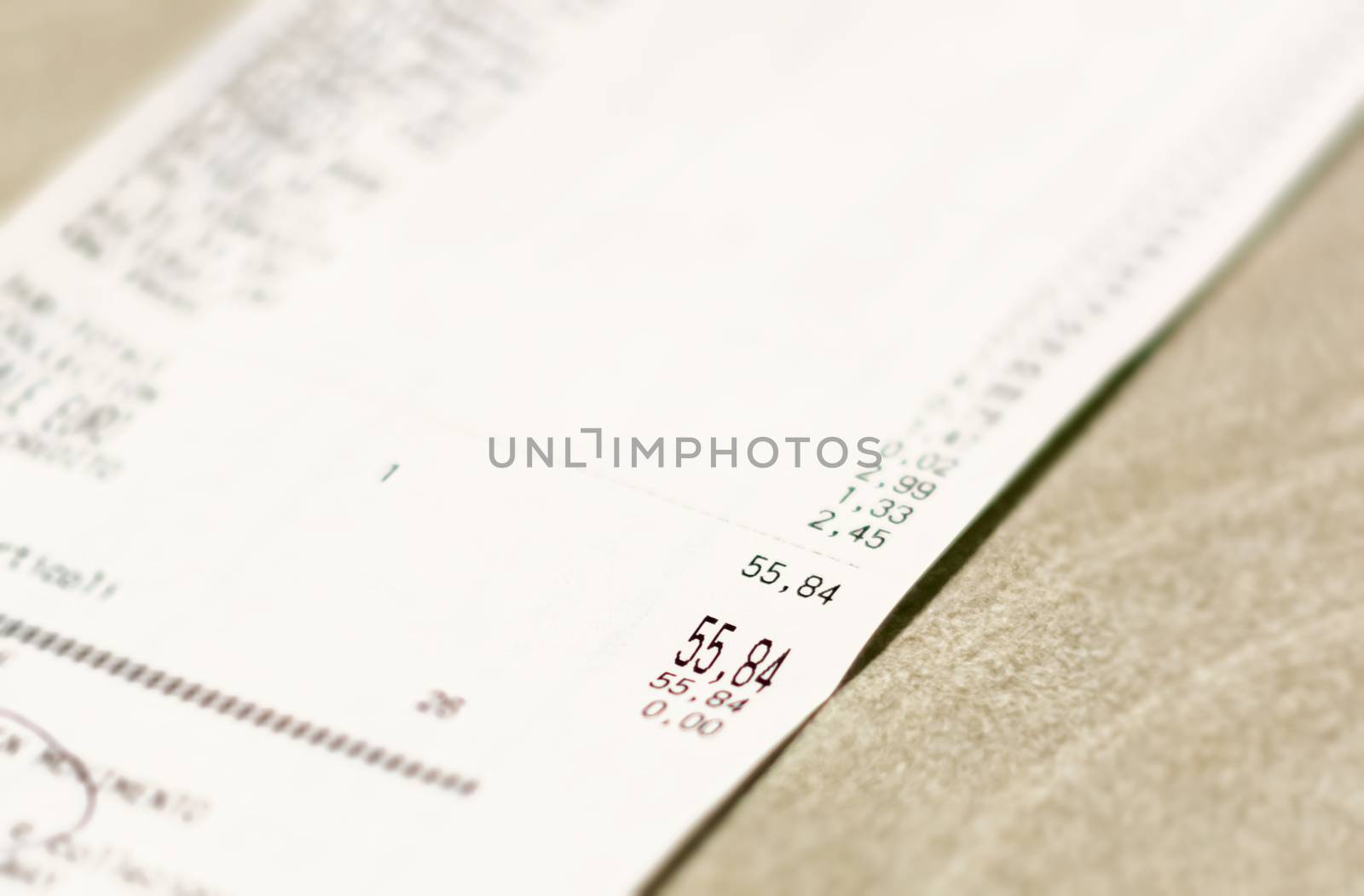 Close-up view of the total amount of supermarket grocery shopping printed on a paper receipt. Grocery shopping list