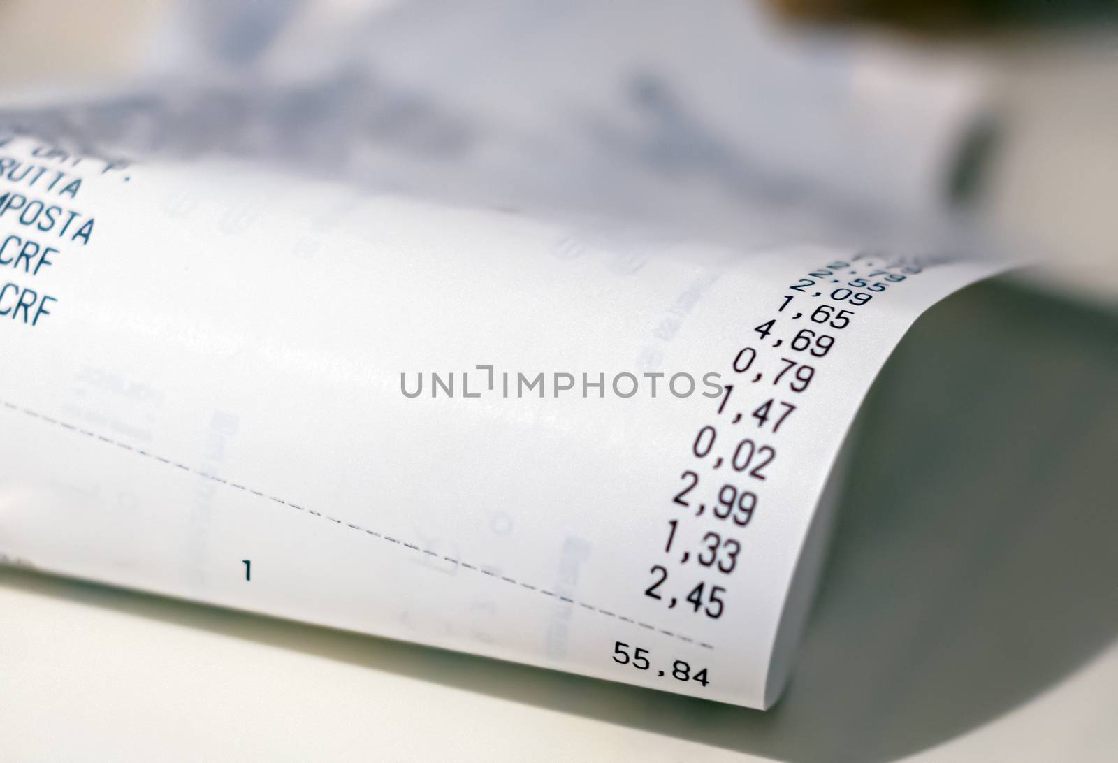 Close-up view of the total amount of supermarket grocery shopping printed on a paper receipt. Grocery shopping list