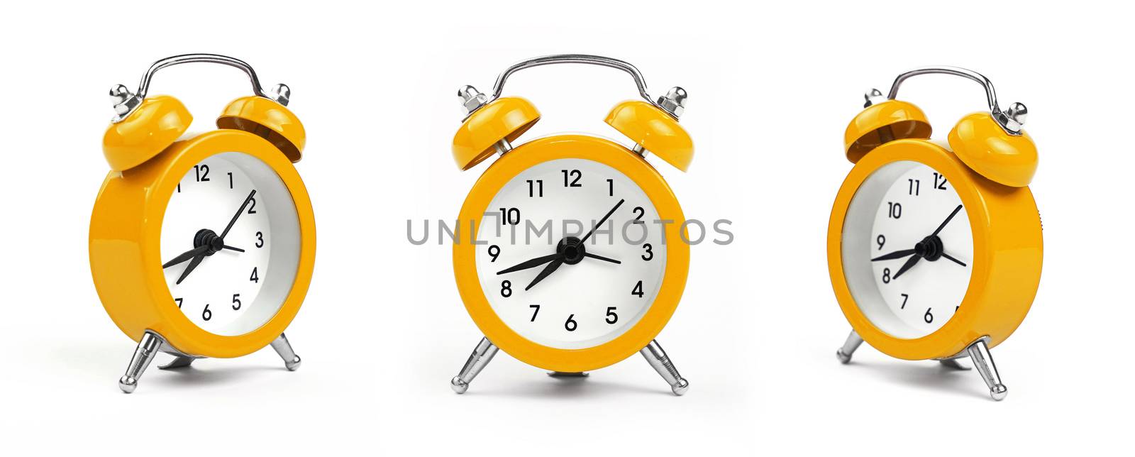 Three small yellow metal alarm clock with red bells over white background, close up, low angle view in different perspectives