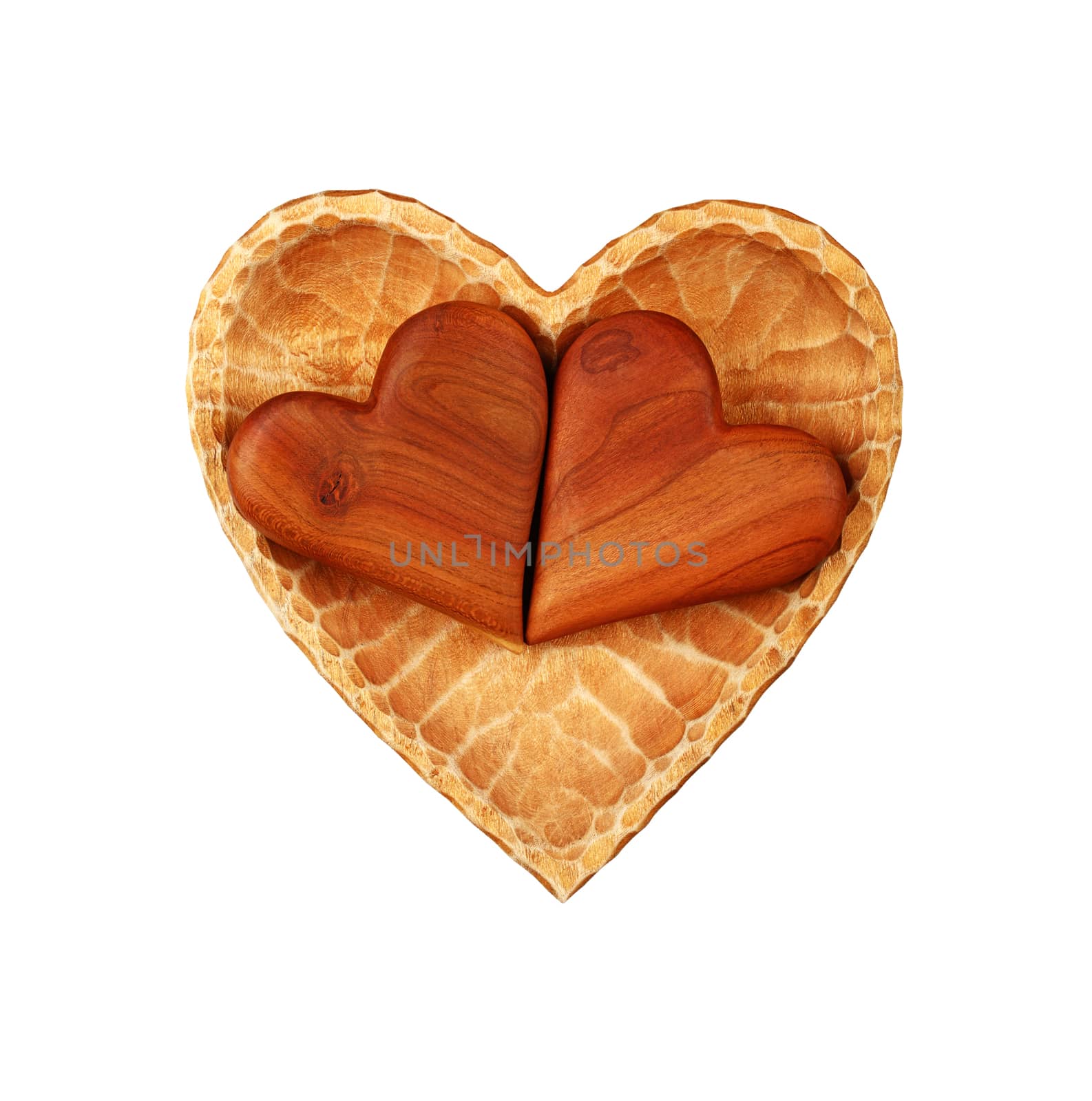 Close up two brown unpainted natural wooden carved hearts in heart shaped bowl isolated on white background