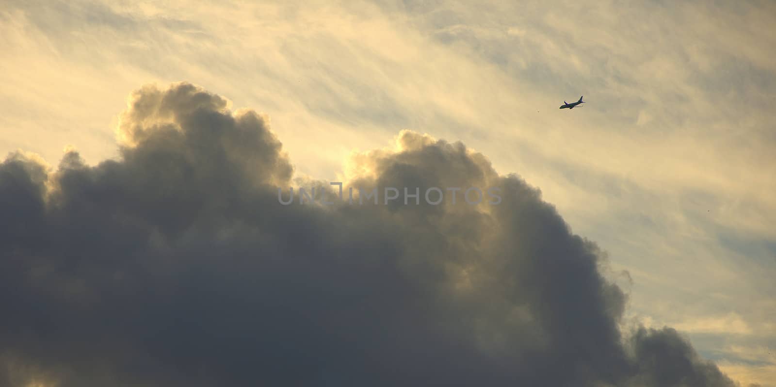 The silhouette of the aircraft in the sky against the background of cirrus clouds. Cloudscape. by alexey_zheltukhin