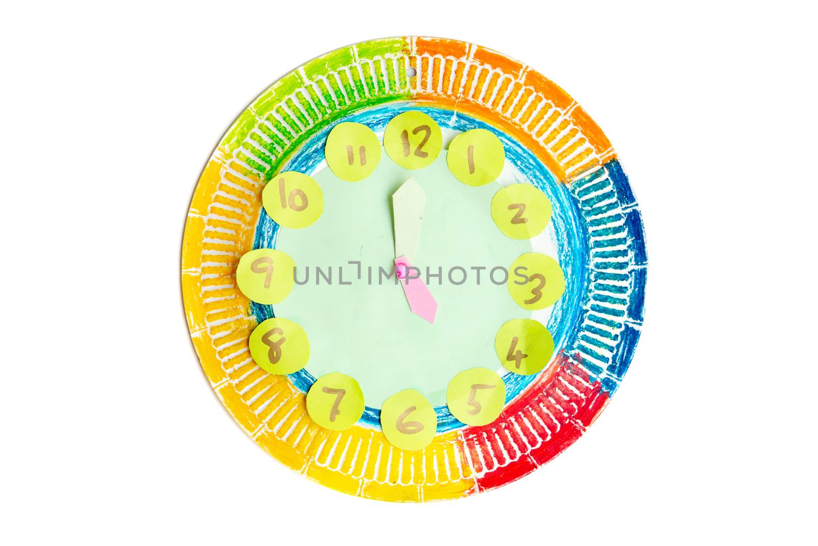 Colorful child handwork clock pointing at 5 o'clock, isolated on white background