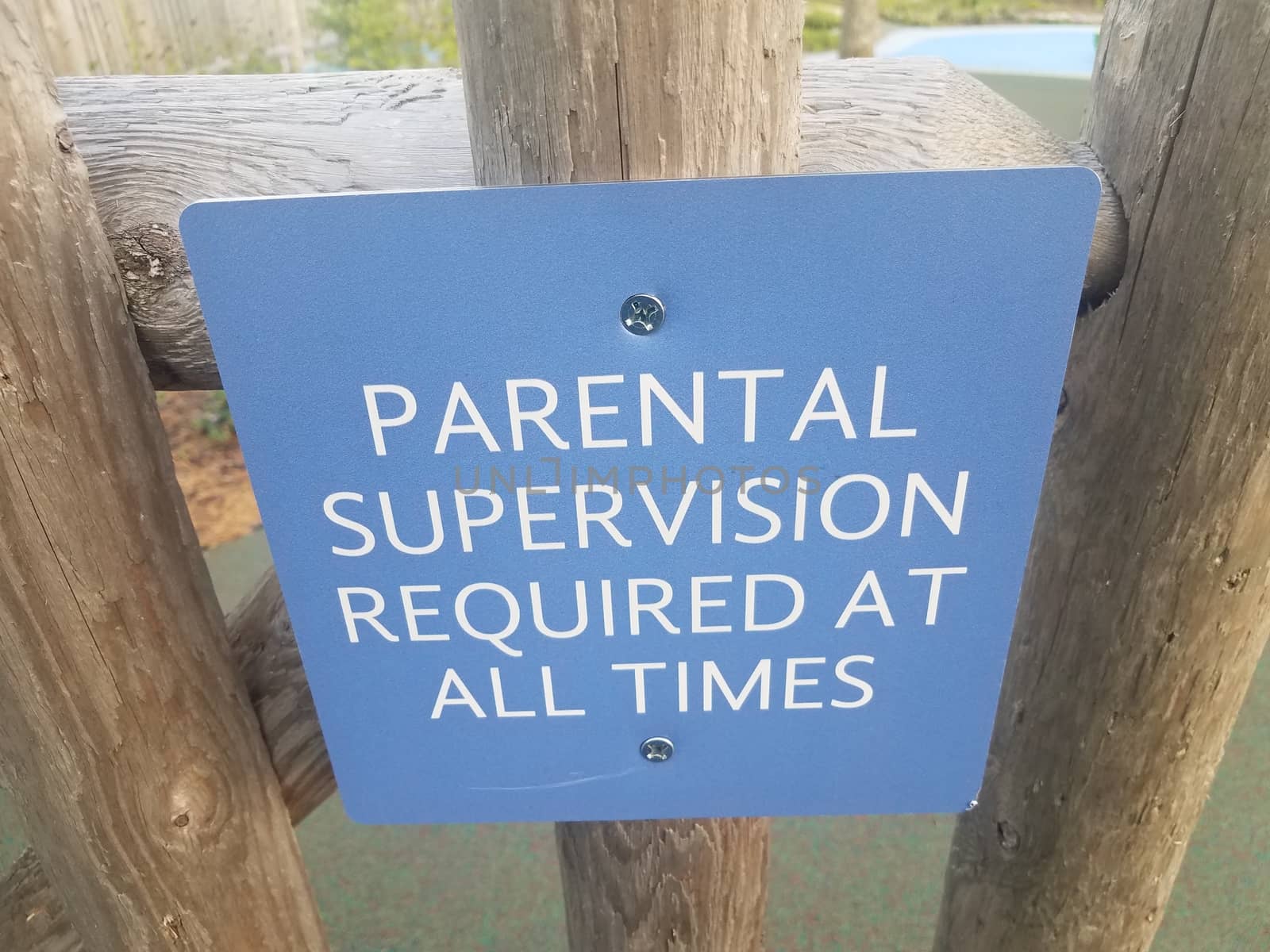 blue parental supervision required at all times sign on wood fence