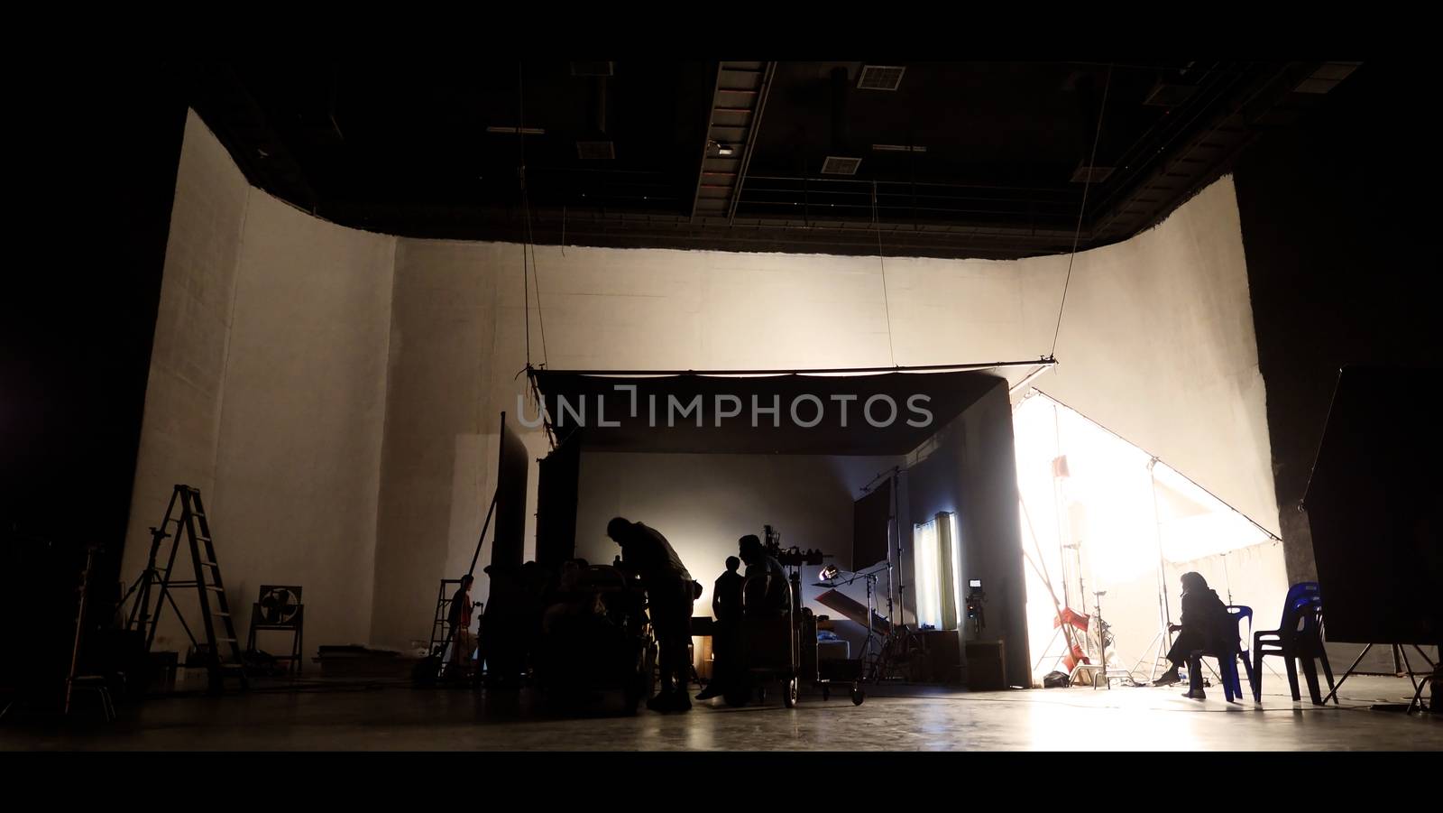 Behind the shooting production crew team and silhouette of camer by gnepphoto