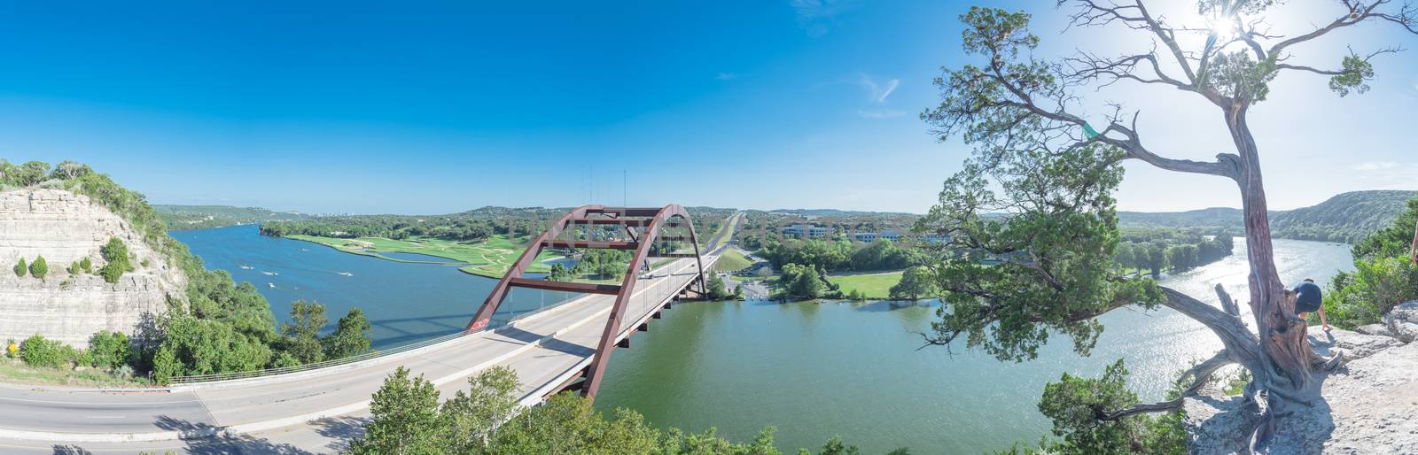 Panoramic Pennybacker Bridge over Colorado river and limestone cliff in Austin by trongnguyen