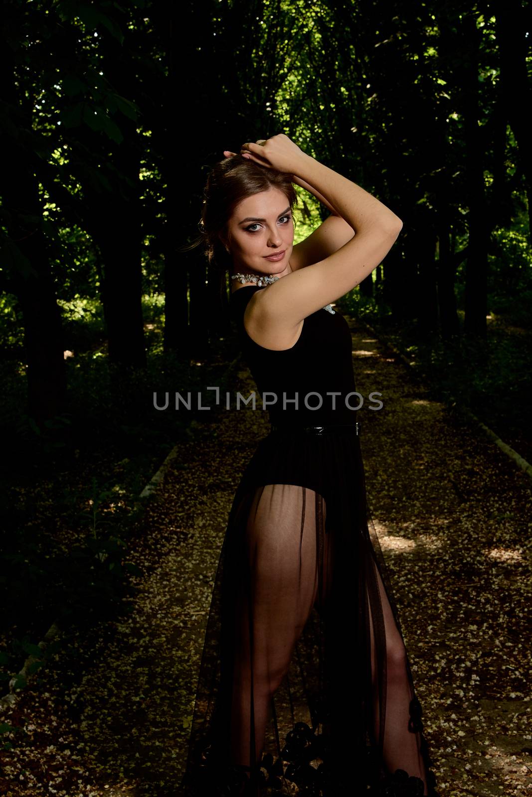 Young attractive woman is wearing the sexy transparent black dress. Young woman modern portrait. by nixrenas