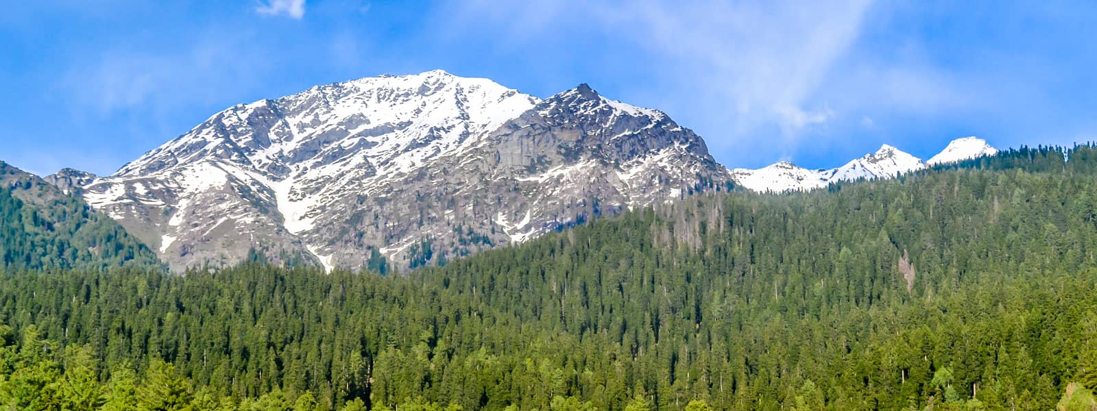 Beautiful view of Pahalgam, known as ‘Valley of Shepherds’ of Kashmir valley (Paradise on Earth) surrounded by snow frozen Himalayas glacier mountains and green fir and pine tree line forest landscape by sudiptabhowmick