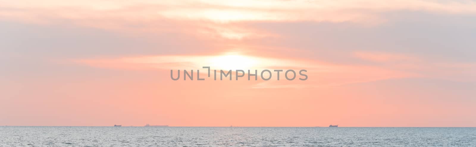 Panorama view scenery sunset on the beach of Melaka, Malaysia. Shipping boat and cruise can seen in the distance