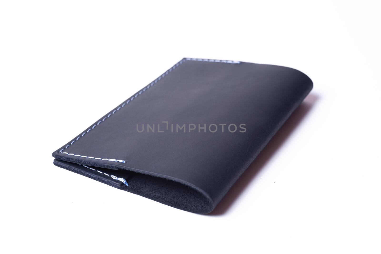 Blue handmade leather passport cover isolated on white background. Cover is closed. Stock photo of luxury businessman accessories.