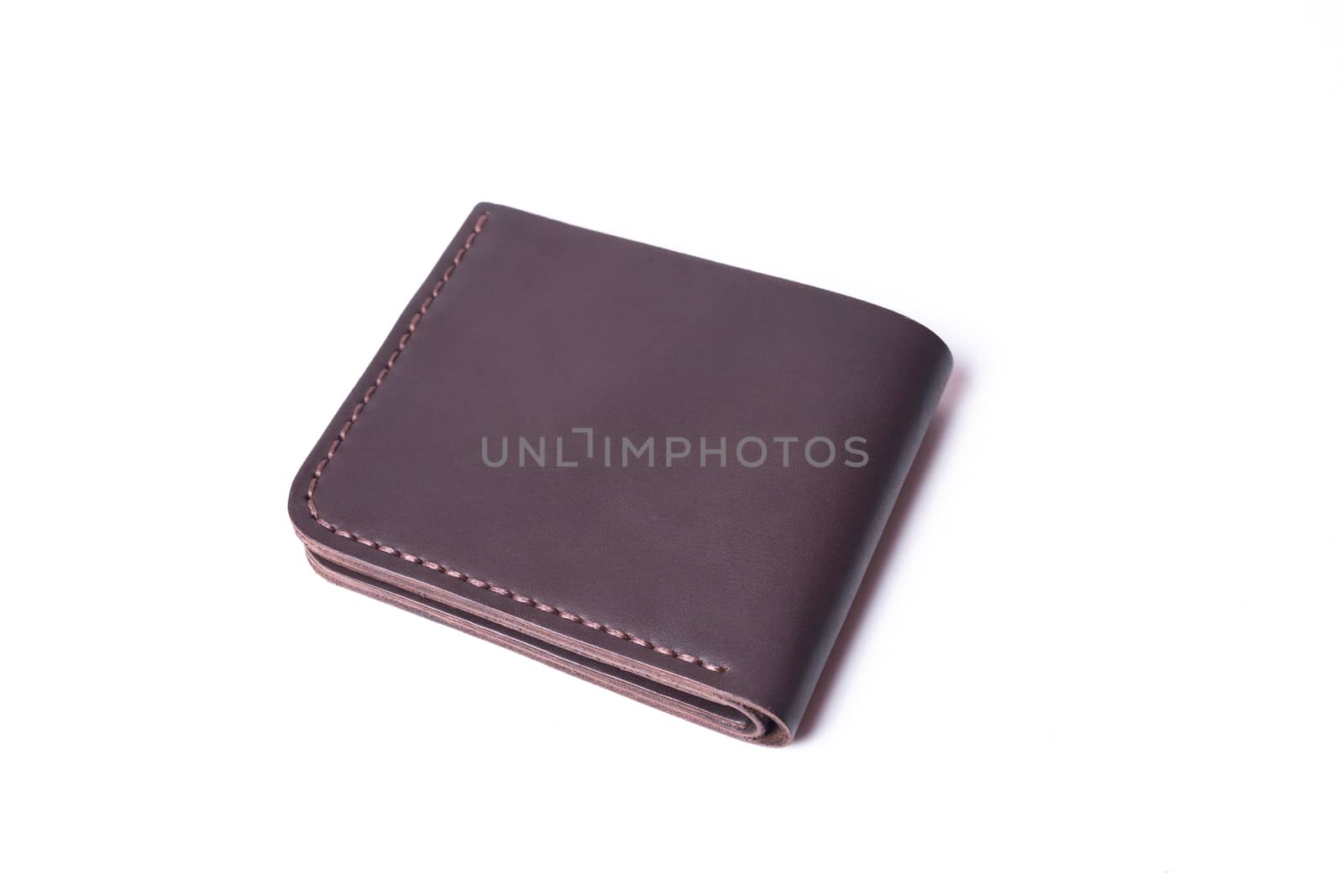 Brown handmade leather wallet isolated on white background. Wall by alexsdriver