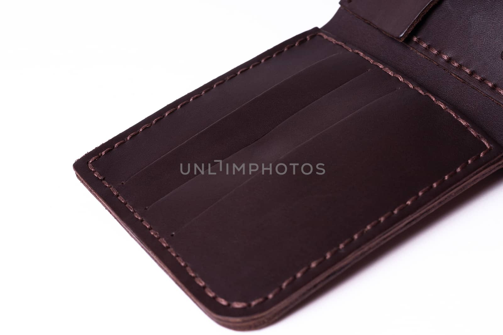 A part of brown handmade leather man wallet isolated on white ba by alexsdriver