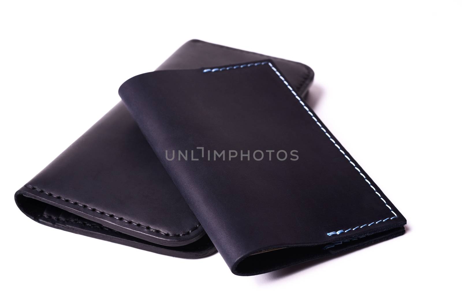 Black handmade leather man wallet and passport cover isolated on by alexsdriver