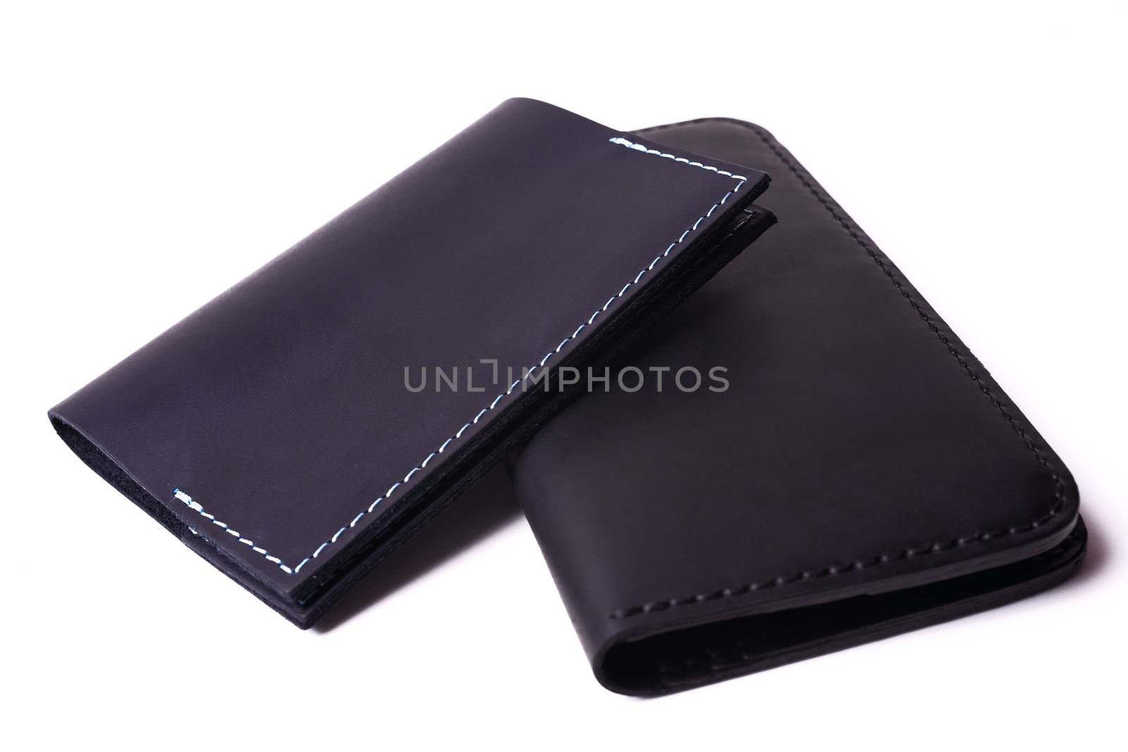 Black handmade leather man wallet and passport cover isolated on by alexsdriver