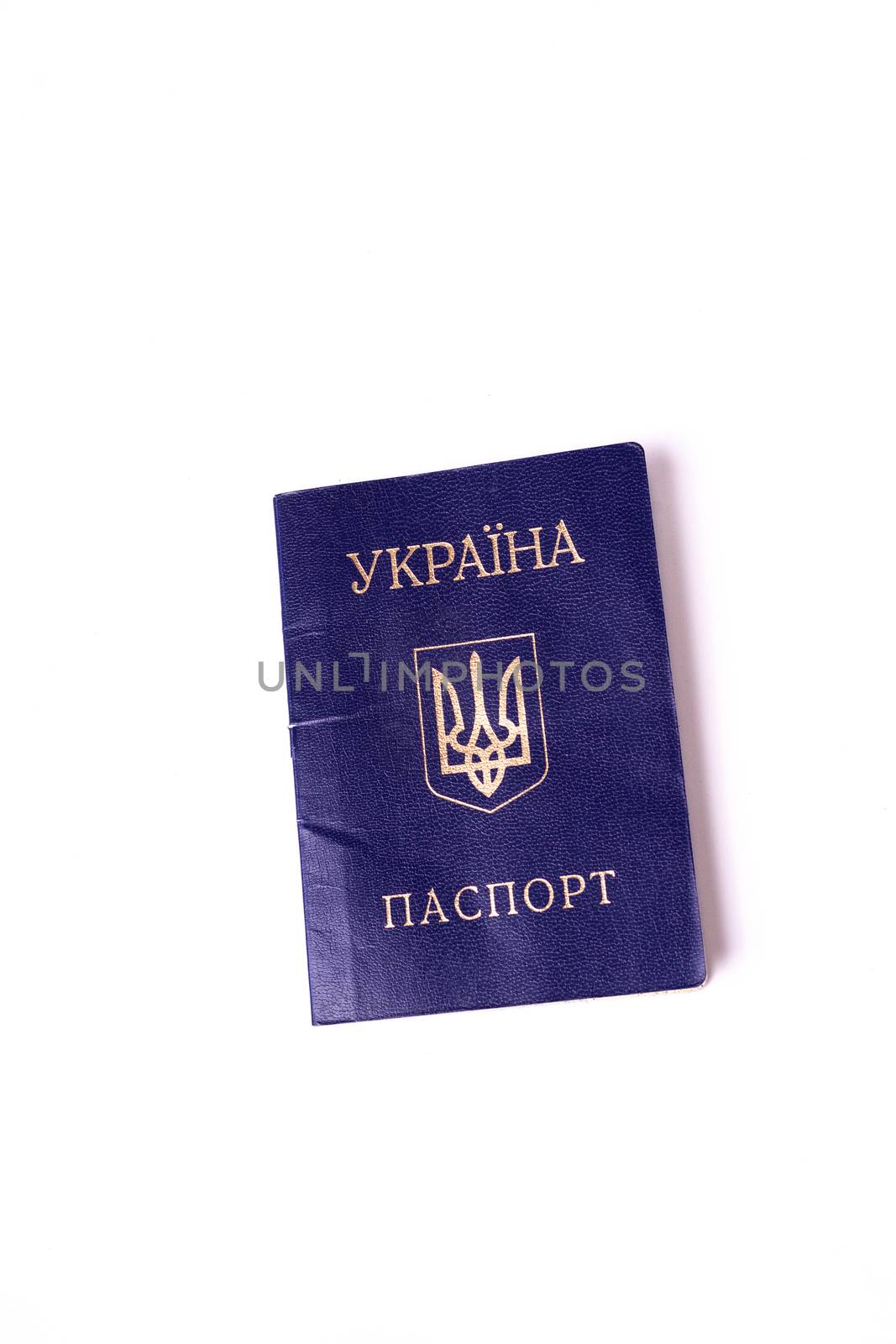 Blue Ukrainian passport isolated on white background. Passport is old and damaged a little bit. Stock photo of travel documents.