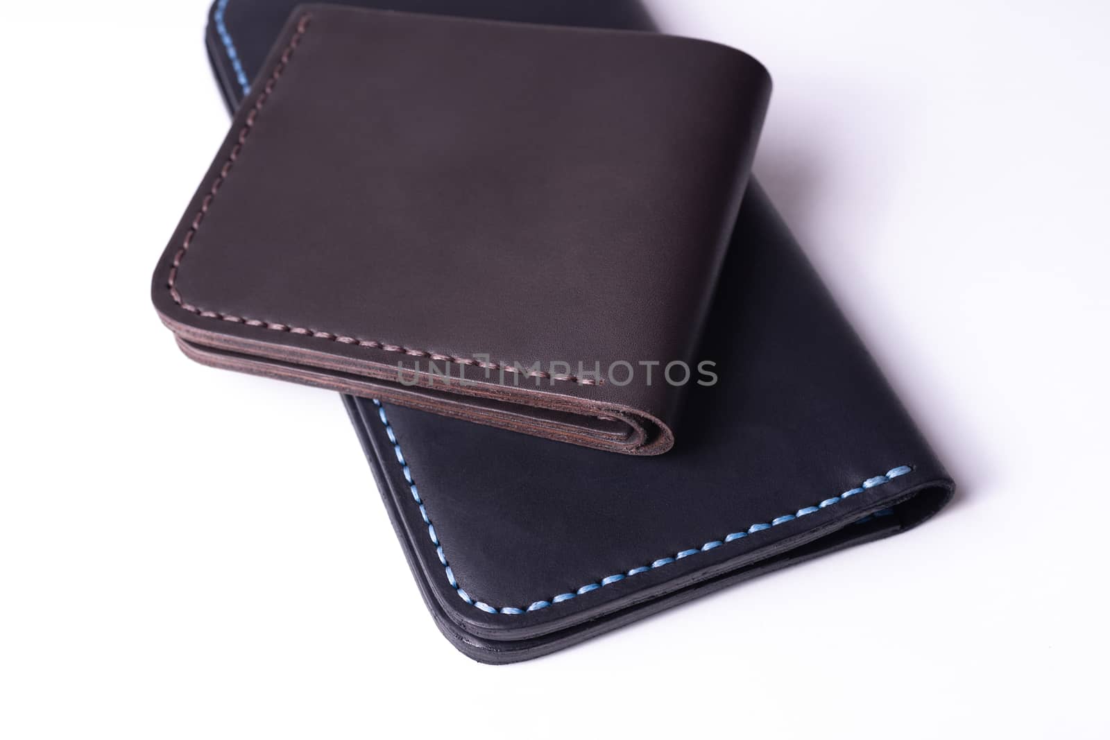 Handmade leather black purse and brown wallet isolated on white background. Stock photo of luxury accessories.